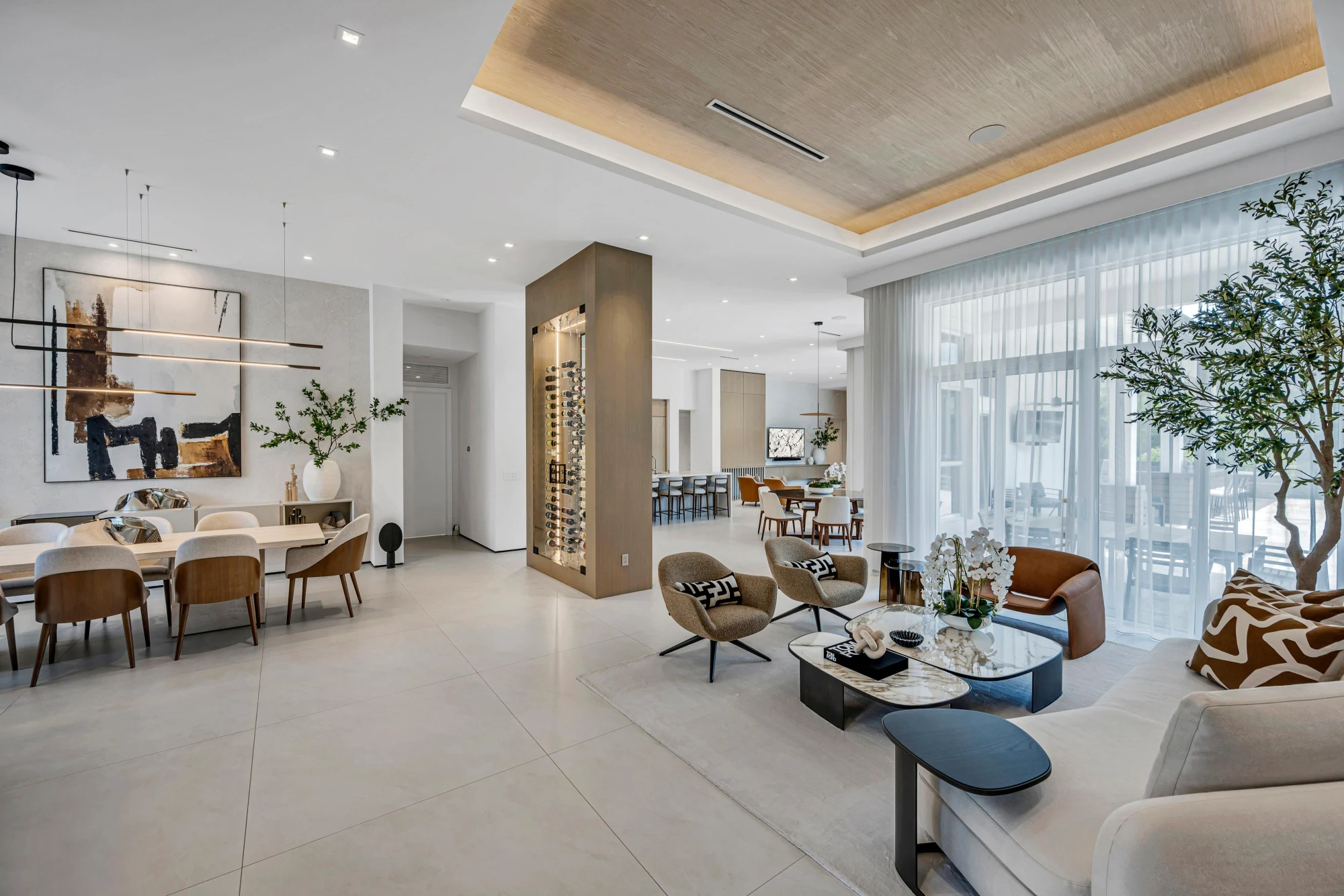 Open great room with a reeded oak ceiling and lit wine column in the Long Lake Ranches estate, Davie, Florida, designed by Luxe Design Studios