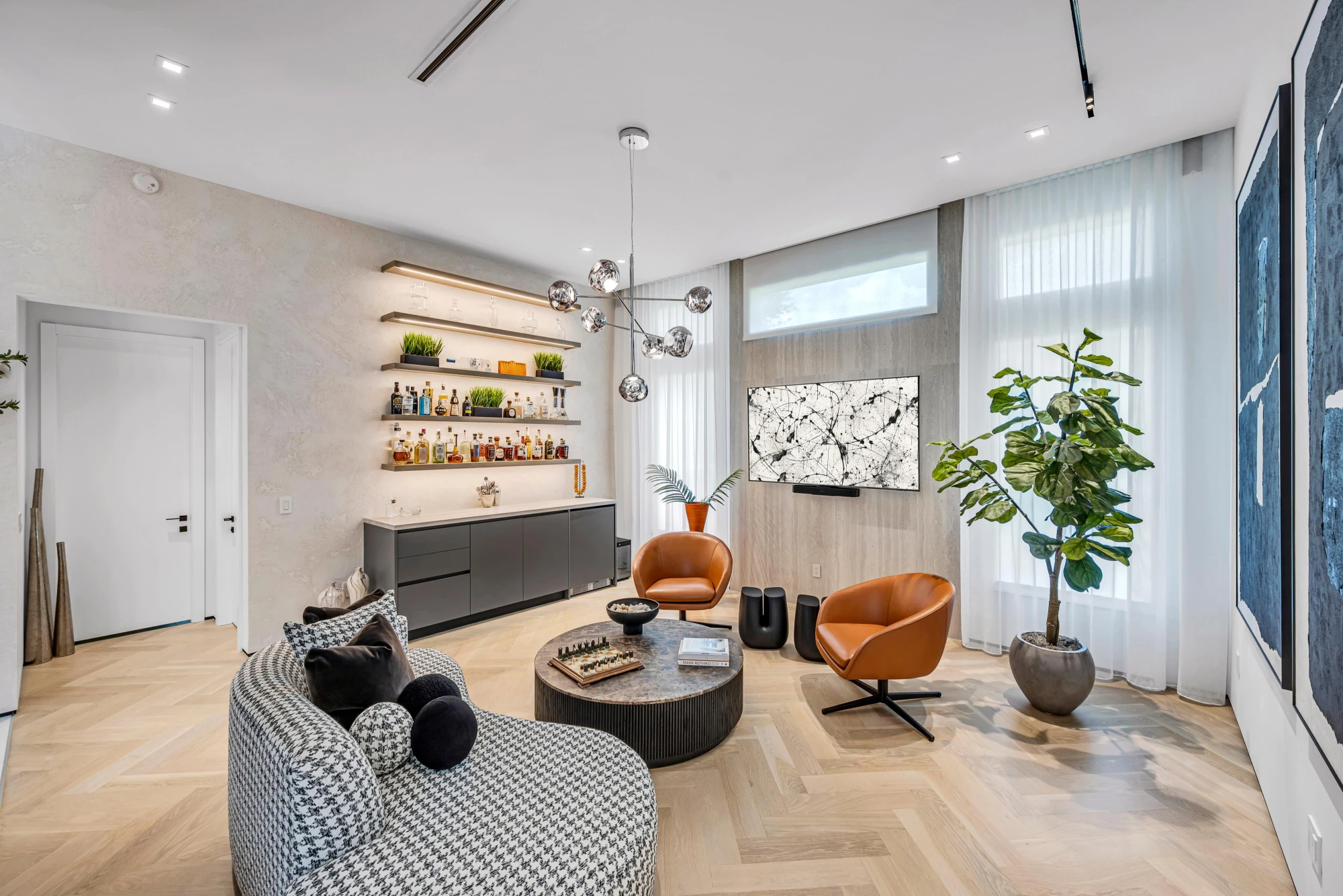 Lounge and bar with lit floating shelves and herringbone oak flooring in the Long Lake Ranches estate, Davie, Florida, designed by Luxe Design Studios