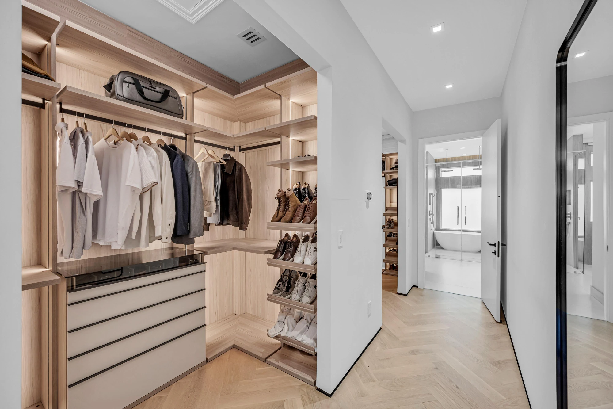 Walk-in closet in custom white oak millwork in the Long Lake Ranches estate, Davie, Florida, designed by Luxe Design Studios